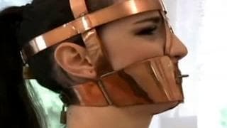 She puts a muzzle on her and then masturbates